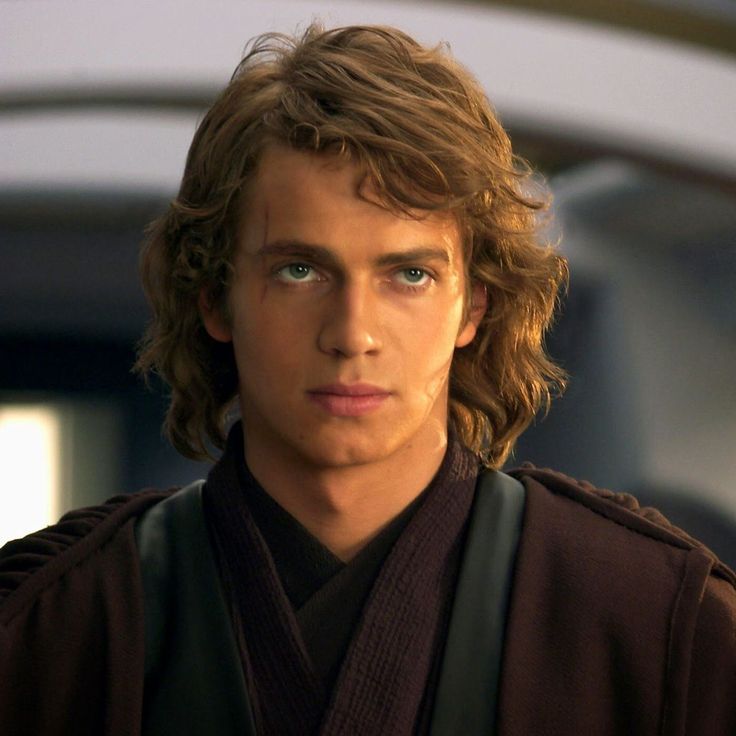 a young man with long hair wearing a star wars outfit and looking at the camera