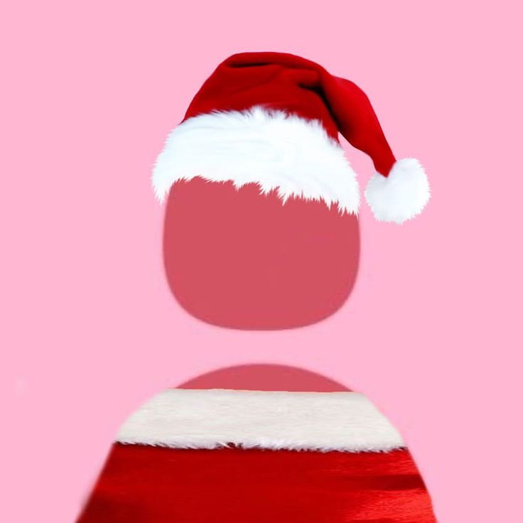 a red and white santa hat on top of a pink background