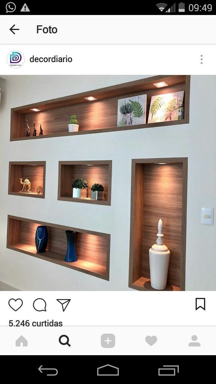 a room with some shelves and vases on the wall next to eachother