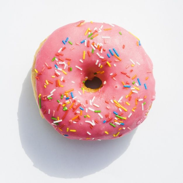 a pink frosted donut with sprinkles on it