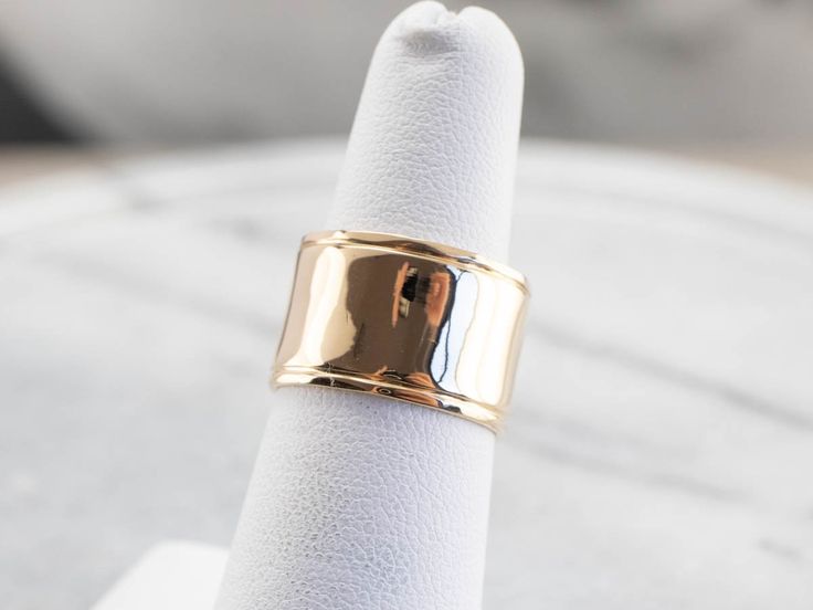 This vintage yellow gold band is absolutely stunning! Also called a cigar band, this ring has a high polish and beautiful shine. The yellow gold has a rich warmth to it that makes the ring all the more eye-catching. Metal: 14K Yellow Gold Width of Band: 12.1 mm Height off Finger: 1.0 mm Ring Size: 6.25 Marks: "14K" Stamped on the inside band Timeless 14k Gold Wide Band Ring With Open Band, Timeless 14k Gold Wide Band Ring With Open Design, Timeless Wide Band 14k Gold Open Ring, Timeless Wide Band Open Ring In 14k Gold, Classic White Gold Thick Band Ring, Elegant Wide Band In Yellow Gold, Classic 14k Gold Wide Band Ring For Anniversary, Formal 14k Stamped Wide Band Ring, Timeless Yellow Gold Wide Band Ring