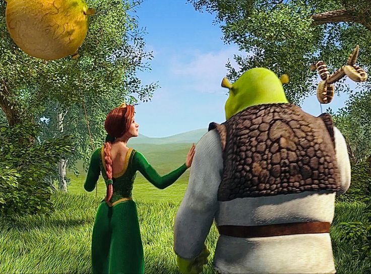 two animated characters standing in the grass near trees and fruit hanging from their mouths, one holding onto another character's arm