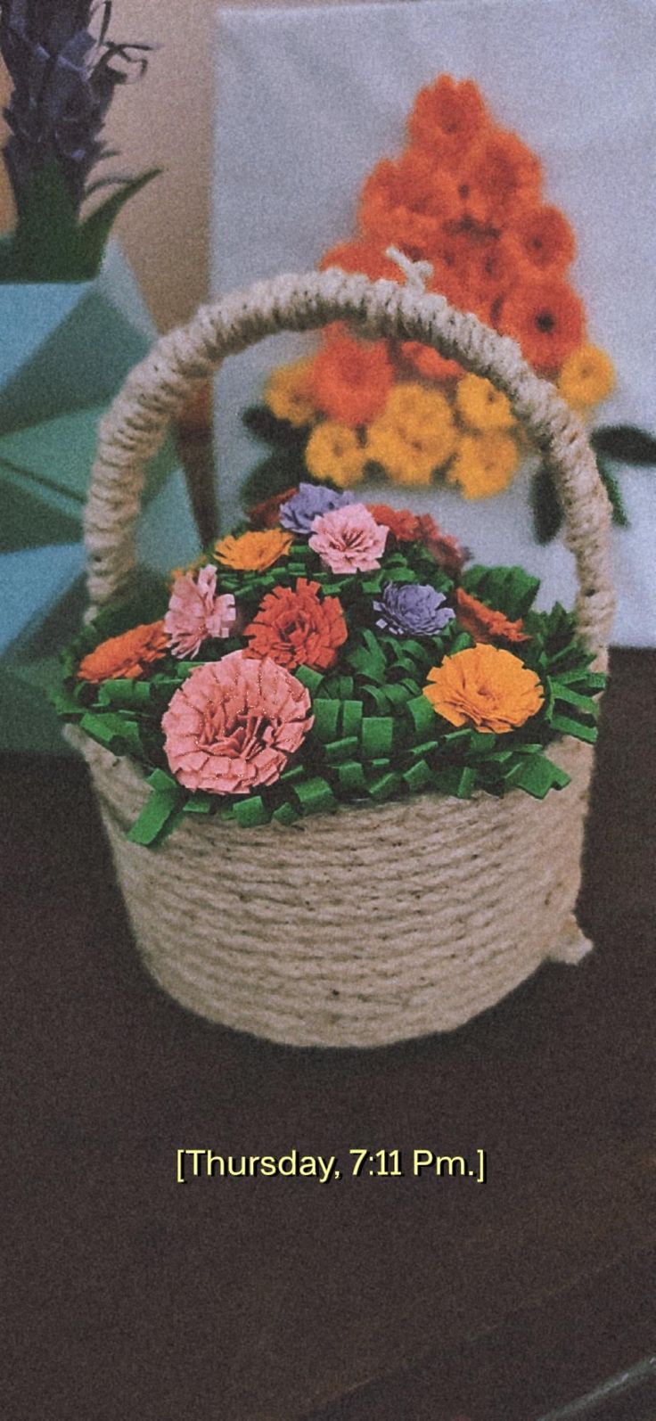 a basket filled with flowers sitting on top of a table