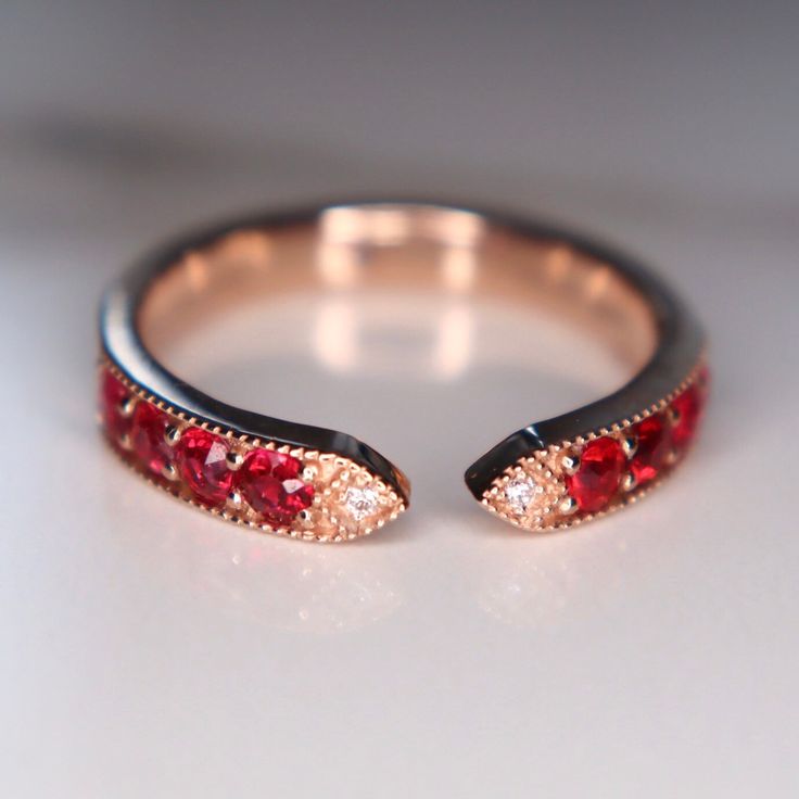 This ring features red spinels and diamonds with the most fascinating red color. The size 6.75 ring is made of solid 18K gold can be sized up or down for $65 if needed. This item is brand new and was appraised by a gemologist. The certificate will be included and describes the spinel as follows: Condition: Brand New & Custom Designed by me  Size: US 6.75 sizable  Metal: Solid 14K Rose Gold  Center Stone: Vivid Red Spinels 0.62ct.  Side Stones: Earth Mined Diamonds 0.05ct  Measurement: 4mm front Red Open Diamond Promise Ring, Red Cubic Zirconia Ruby Ring For Formal Occasions, Red Ruby Ring With Cubic Zirconia For Formal Occasions, Red Ruby Ring With Vvs Clarity Diamond, Red Ruby Ring With Vvs Clarity, Lab-created Ruby Rings With Rose Cut Diamonds For Promise, Red Ruby Ring With Vvs Clarity And Round Cut, Red Ruby Ring With Single Cut Diamonds, Red Sapphire Ring With Prong Setting For Anniversary