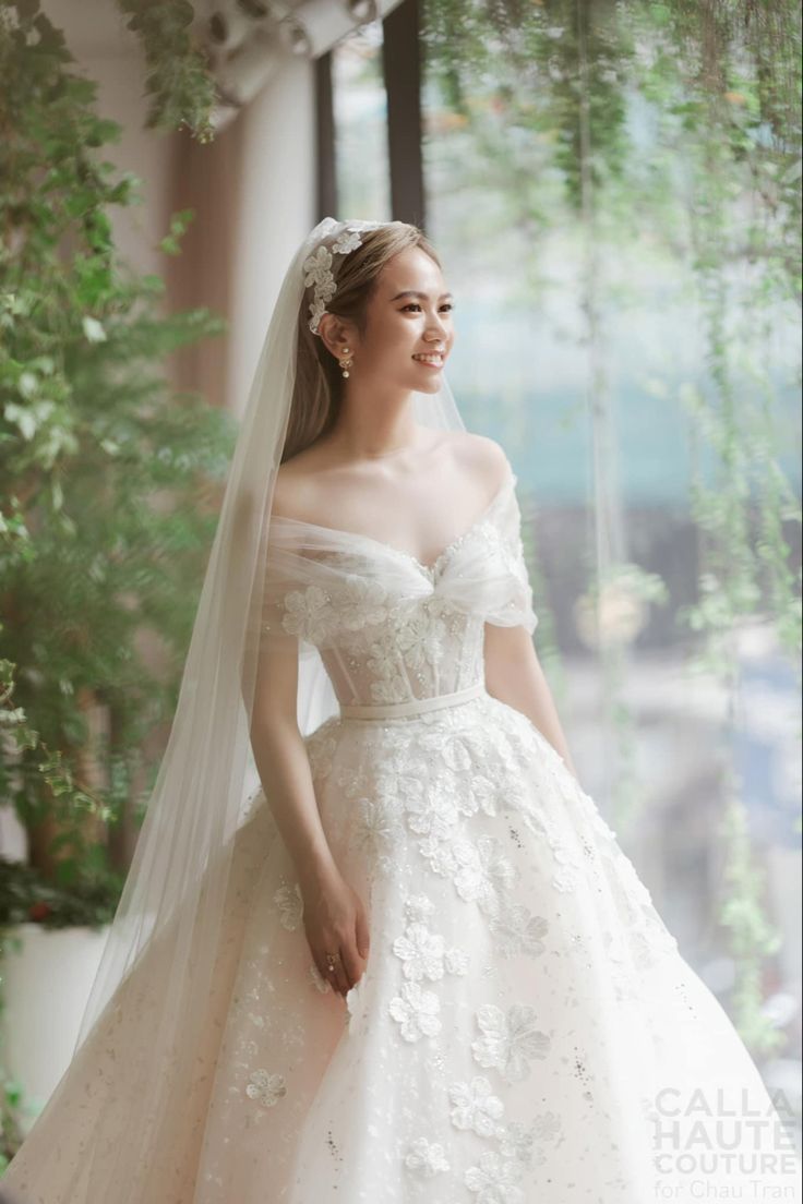 a woman wearing a wedding dress and veil