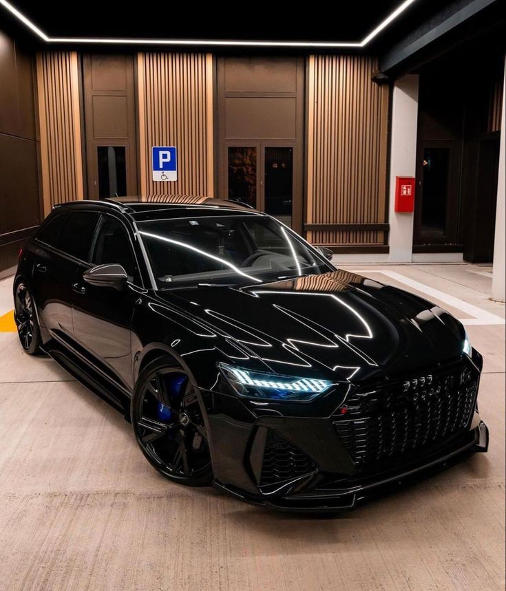 a black car parked in front of a building