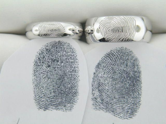 two fingerprints are attached to the back of a pair of cufflinkers