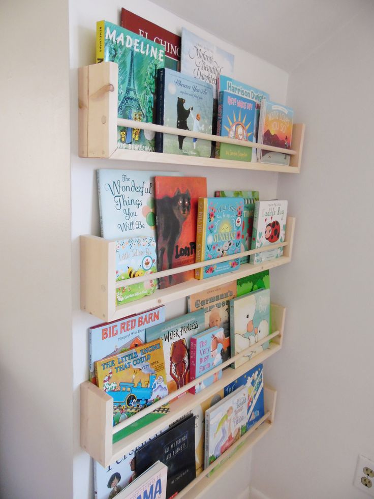 the bookshelf is filled with children's books