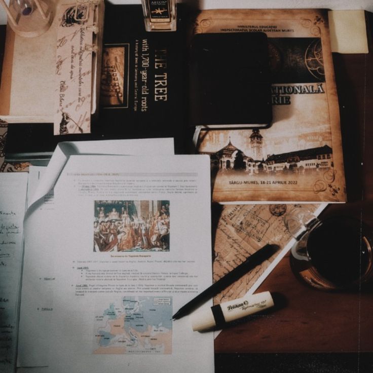 an assortment of books and papers on a table