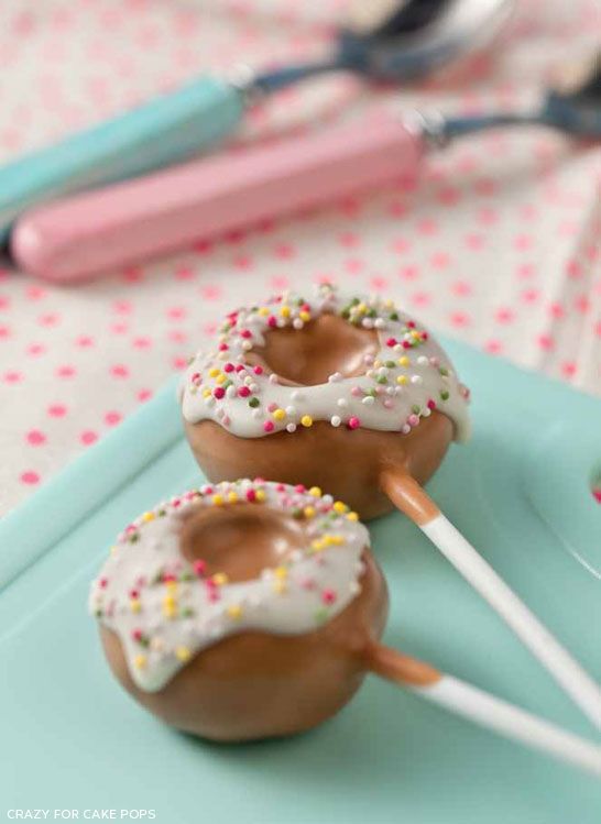 three donuts with sprinkles on them sitting on top of a blue plate