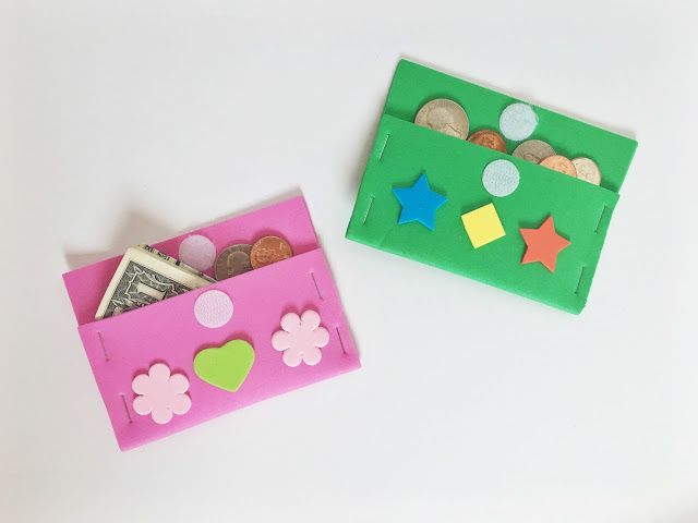 two small pink and green boxes with money in them