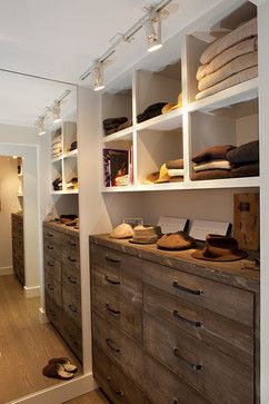 a walk in closet filled with lots of drawers and shoes on top of wooden dressers