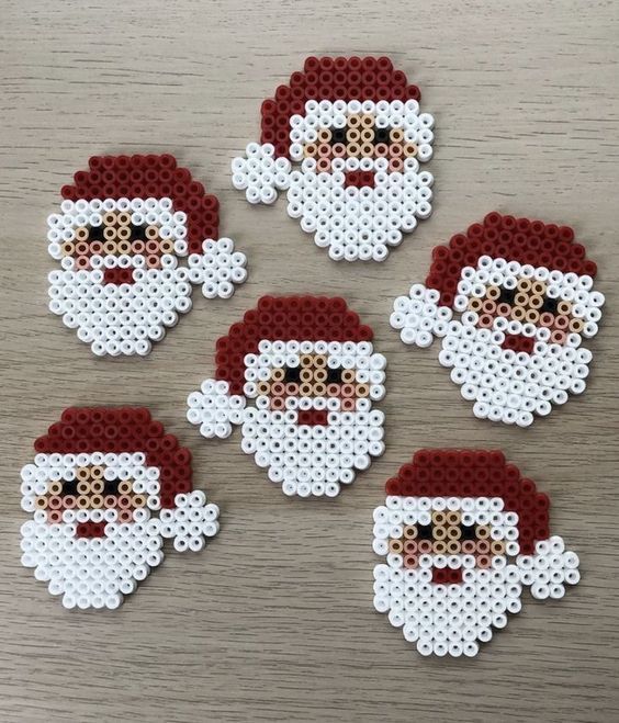 six pixelated santa claus stickers sitting on top of a wooden table