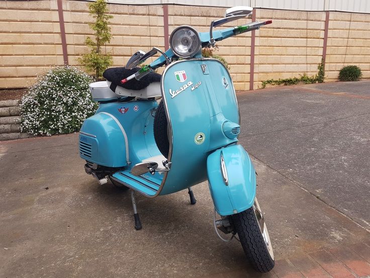 a blue scooter parked in front of a building