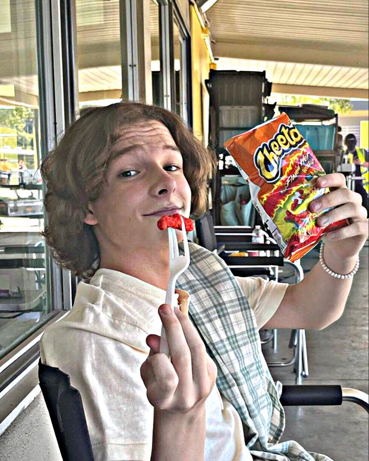 a man eating candy while sitting on a bus