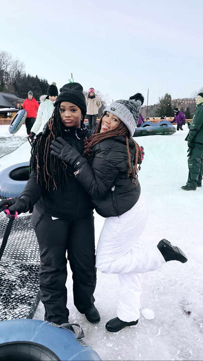 two women are standing in the snow together