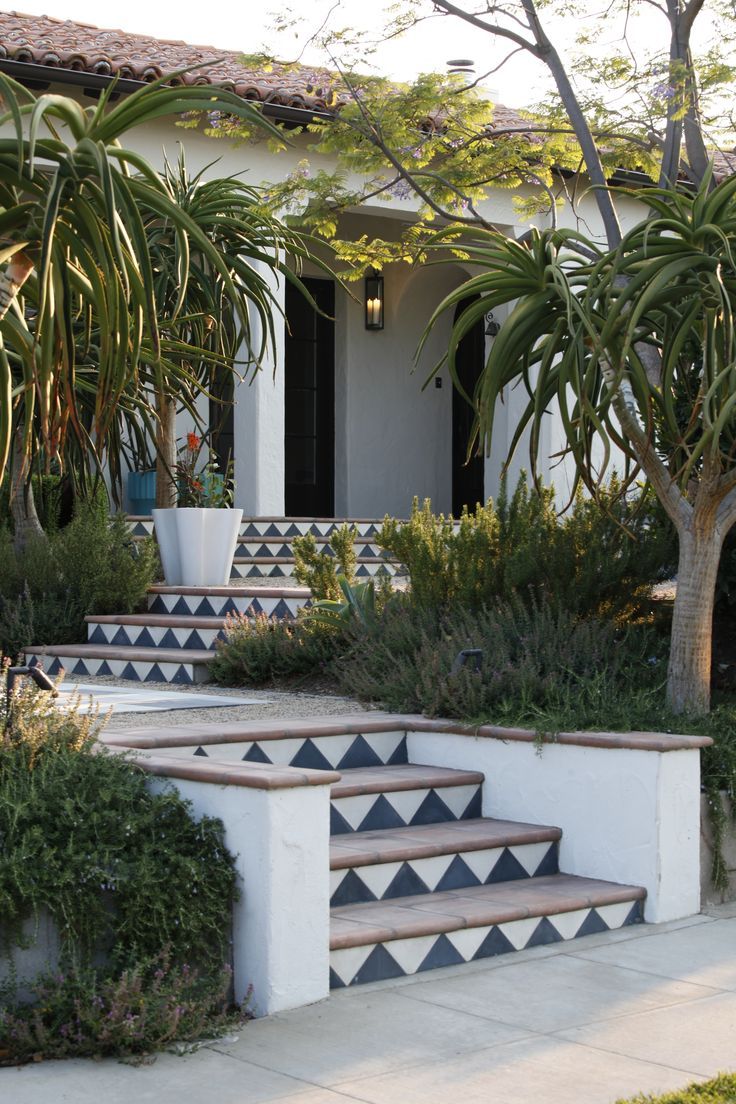 a house with some plants on the steps