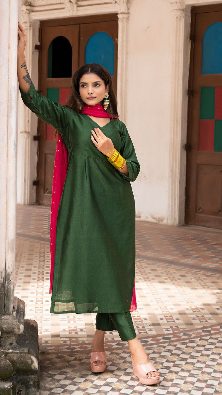 Bring on the festive spirit with our kurta set in chanderi silk. Fully lined kurta and pants. Made in chanderi silk. Dupatta in mul cotton with intricate tikki details. Color of Kurta + Pants : Dark Green. Color of Dupatta : Rani Pink. Model height is 5.3” and is wearing a size S. Wash Care : Dry Clean Only Semi-stitched Cotton Silk Kurta With Gota Work, Cotton Silk Salwar Kameez With Gota Work, Cotton Silk Churidar With Gota Work, Unstitched Slub Silk Kurta For Navratri, Straight Cotton Silk Salwar Kameez With Cutdana, Slub Silk Straight Kurta Salwar Kameez With Dupatta, Straight Salwar Kameez In Cotton Silk With Cutdana, Navratri Straight Kurta In Slub Silk, Transitional Celebration Chanderi Unstitched Suit