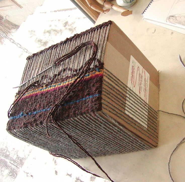 a piece of cardboard sitting on top of a table next to some scissors and thread