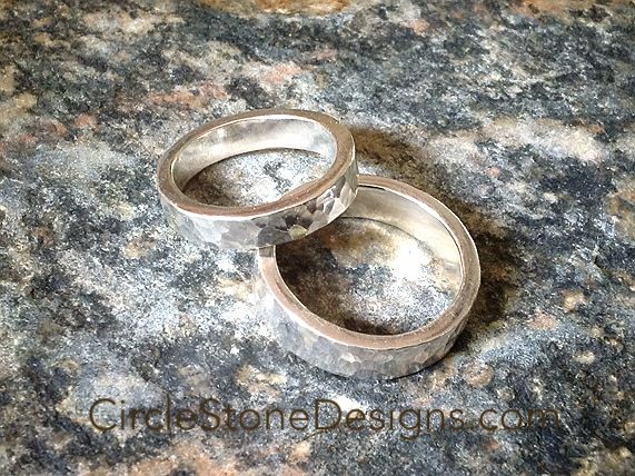 two wedding rings sitting on top of a granite counter