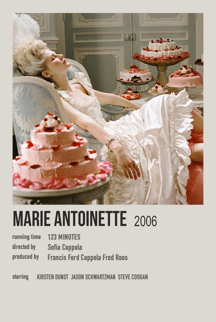 a woman in white dress laying on chair next to cake