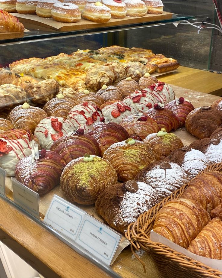 many different types of pastries on display in a bakery