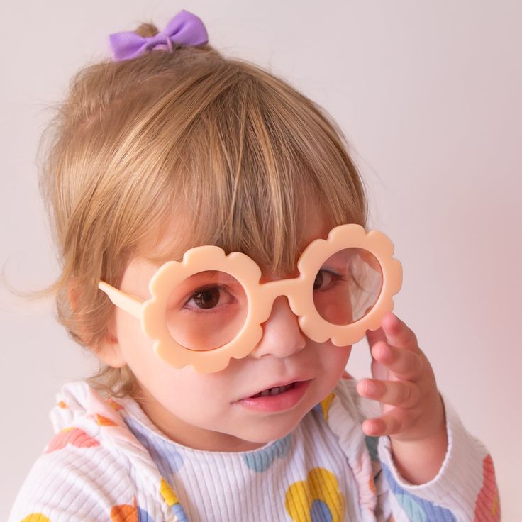 Let your little one's style bloom with these adorable, flower-shaped sunglasses in the shade Apricot! Keep your kiddo stylish and protected with this must-have accessory. Perfect for sunny days and even sunnier moods! One size 1-5 years UV protection Playful Orange Plastic Sunglasses, Playful Polarized Sunglasses For Spring, Whimsical Sunglasses With Uv Protection For Beach, Whimsical Beach Sunglasses With Uv Protection, Playful Sunglasses For Summer Playtime, Playful Sunglasses With Uv Protection, Fun Plastic Sunglasses For Playtime, Playful Plastic Sunglasses With Gradient Lenses, Playful Sunglasses With Gradient Lenses