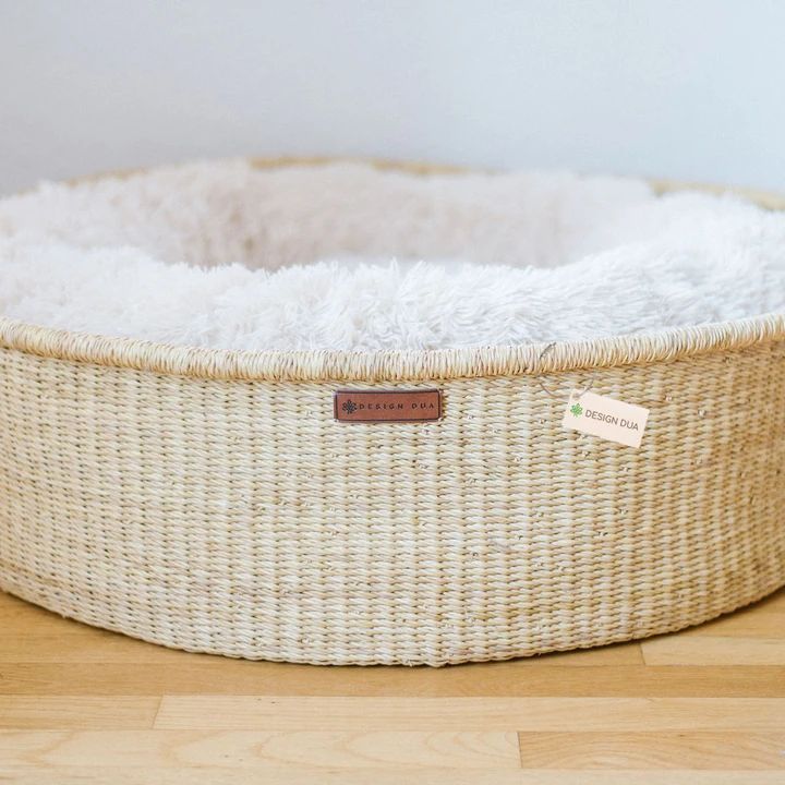 a dog bed made out of wicker with a label on the front and bottom