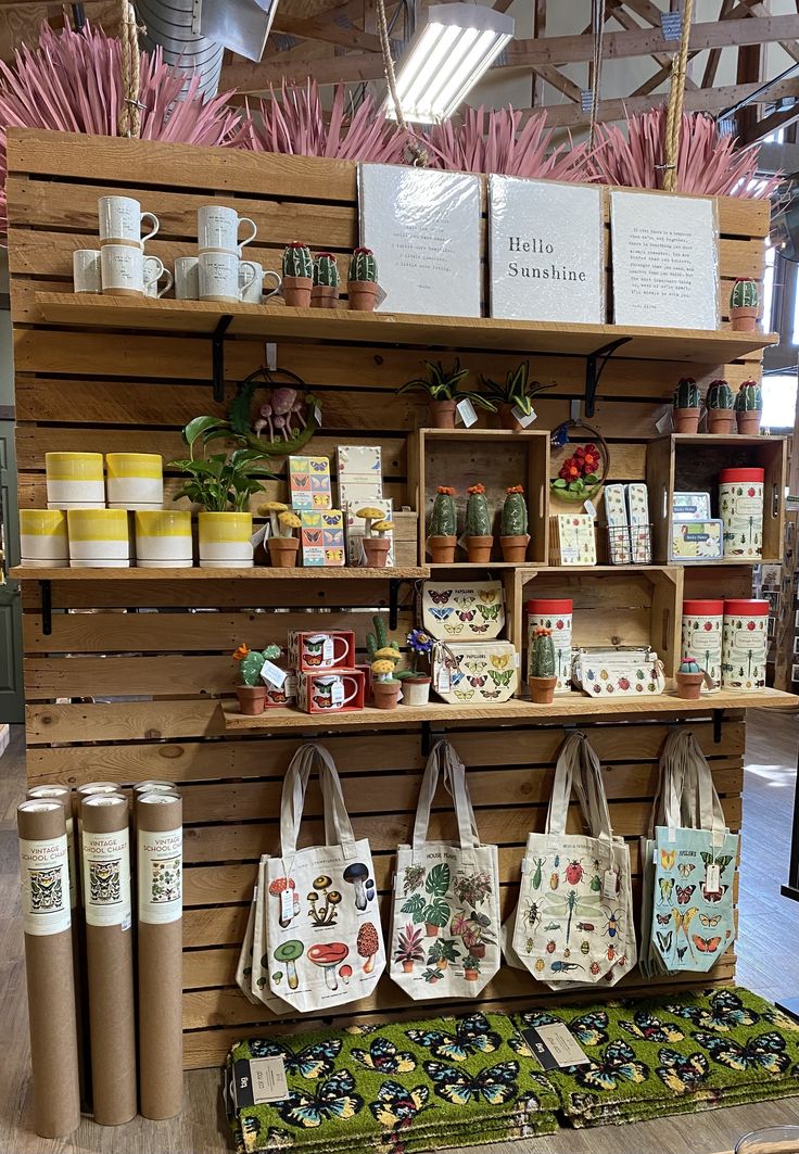 the shelves are filled with many different types of bags and mugs, along with other items