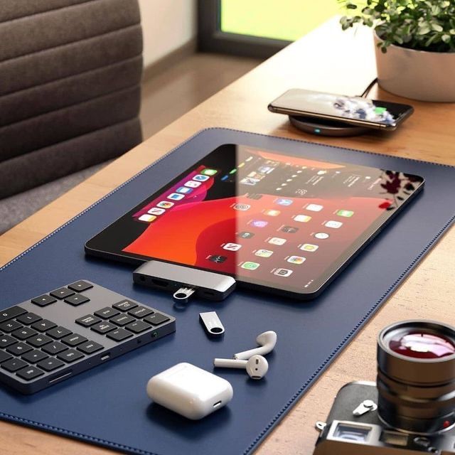 an ipad, keyboard and other electronics on a table