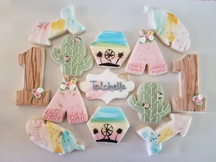 decorated cookies are arranged on a white surface