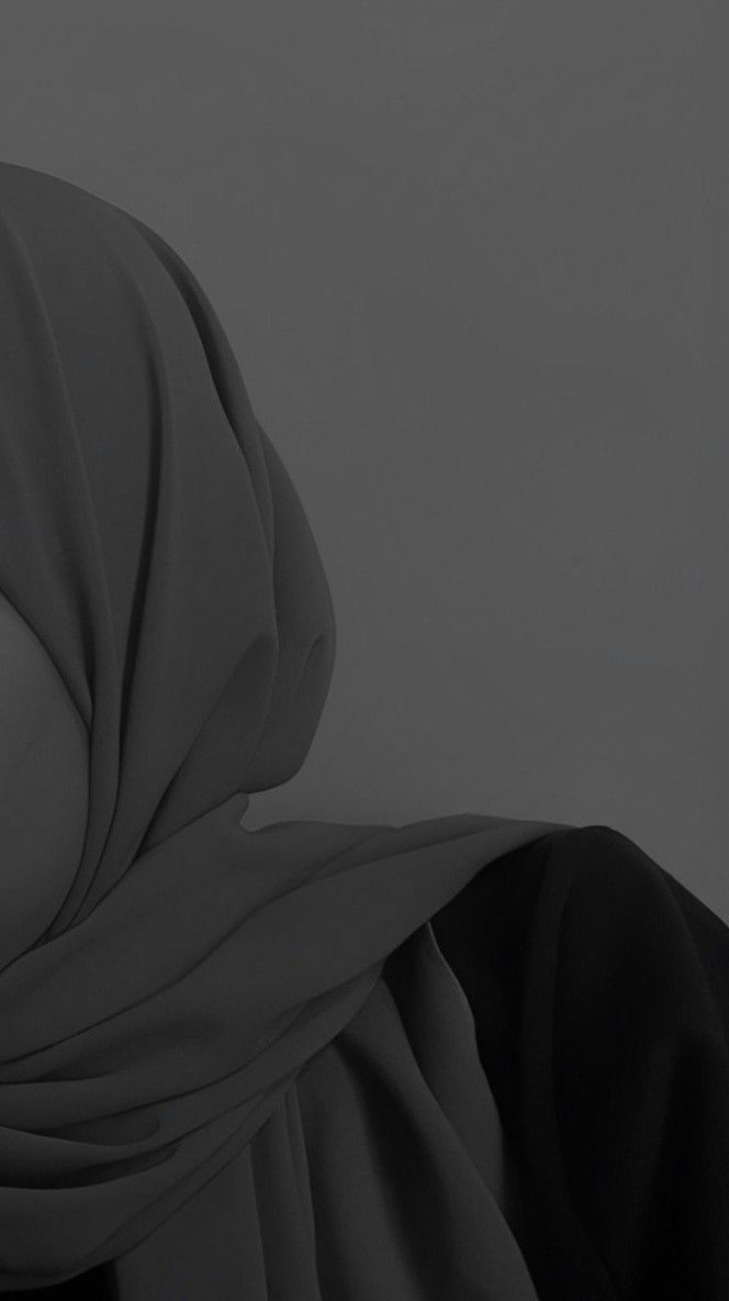 a woman wearing a hijab and looking off into the distance