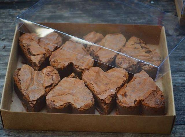 a box filled with brownies sitting on top of a wooden table