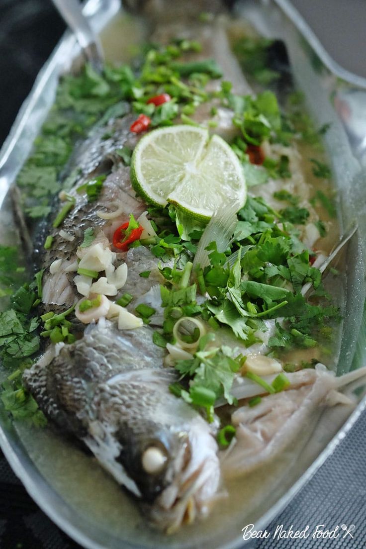 a plate with some fish on it and garnished with cilantros