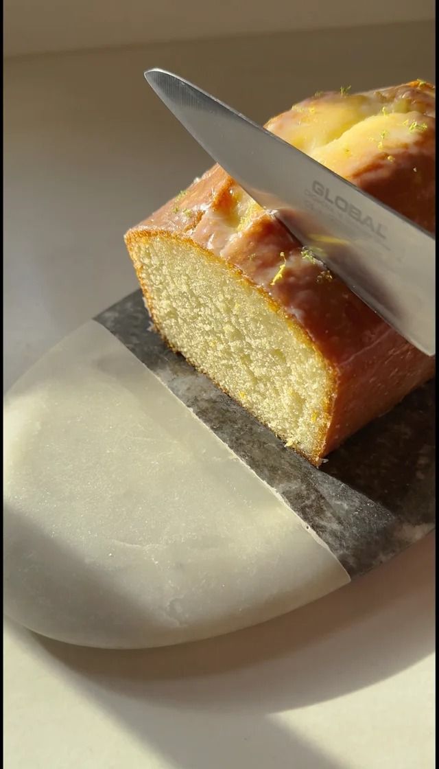 a piece of bread is being cut with a knife