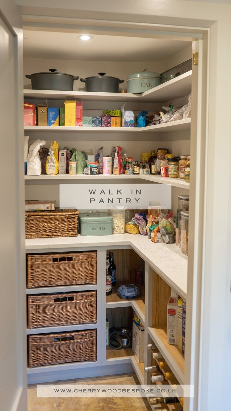 an organized pantry with baskets, food and other items in the shelves on either side