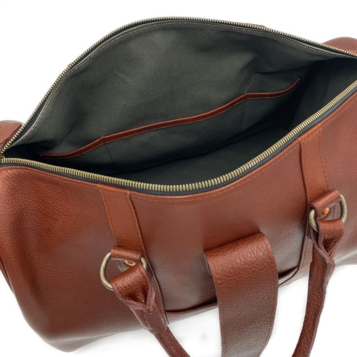 Elevate your carry-on with our newest bag the Travel Duffle. A bag that gets you anywhere you need to go, from the conference room to a weekend retreat, packing everything you need in style. Handcrafted in full-grain leather with antique brass hardware and storage compartments both inside and out. Complete with zipper closure, top strap buckle accent, smooth and sturdy handles, and removable crossbody strap. Details Double top handles Adjustable 54" crossbody strap Zipper and front clasp closure Travel Duffle Bag, Mens Travel, Antique Brass Hardware, Travel Duffle, Duffle Bag Travel, Storage Compartments, Brass Hardware, A Bag, New Bag