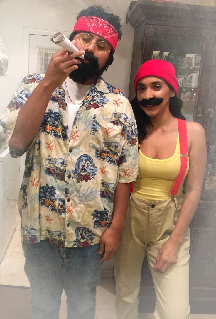 two people standing next to each other with fake mustaches