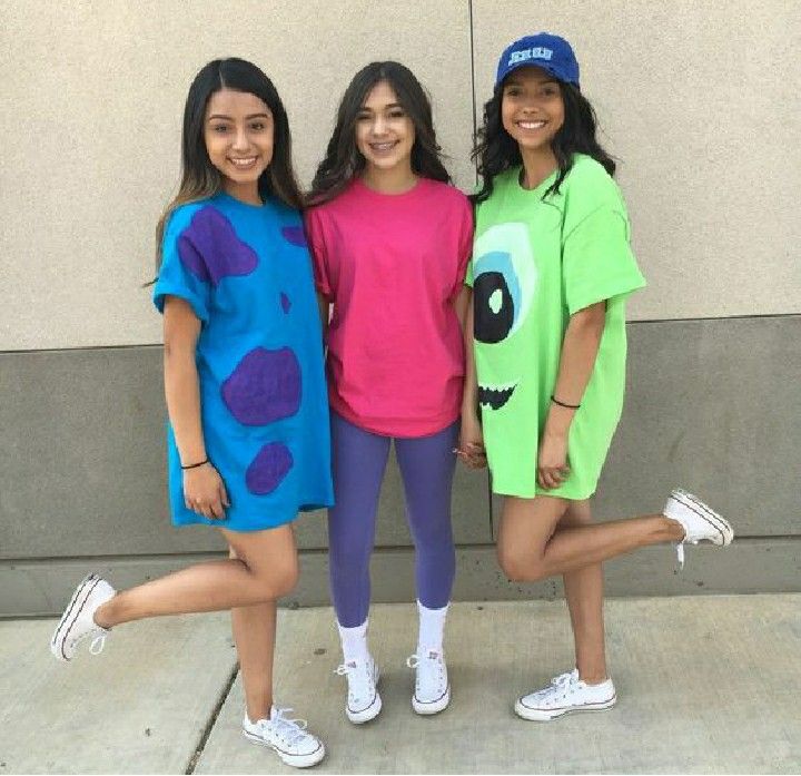 three girls dressed up in costumes posing for the camera