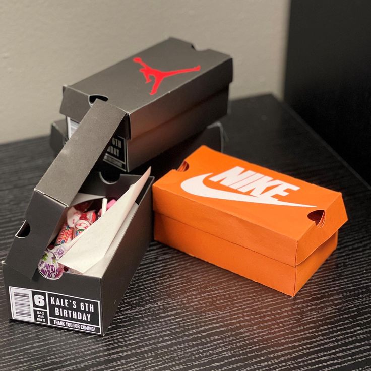 an open nike box sitting on top of a table next to another box with the air jordan shoe in it