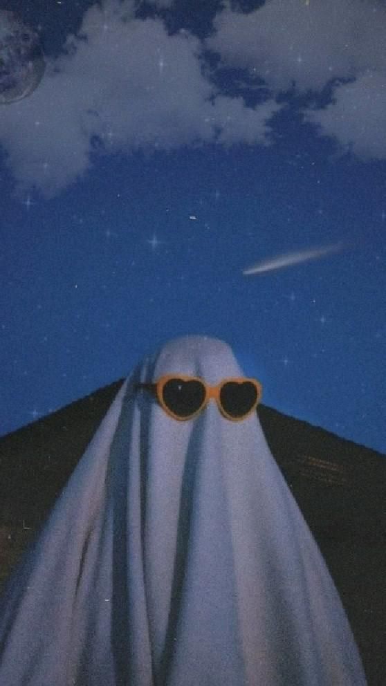 a ghost with heart shaped sunglasses standing in front of a sky filled with stars and clouds