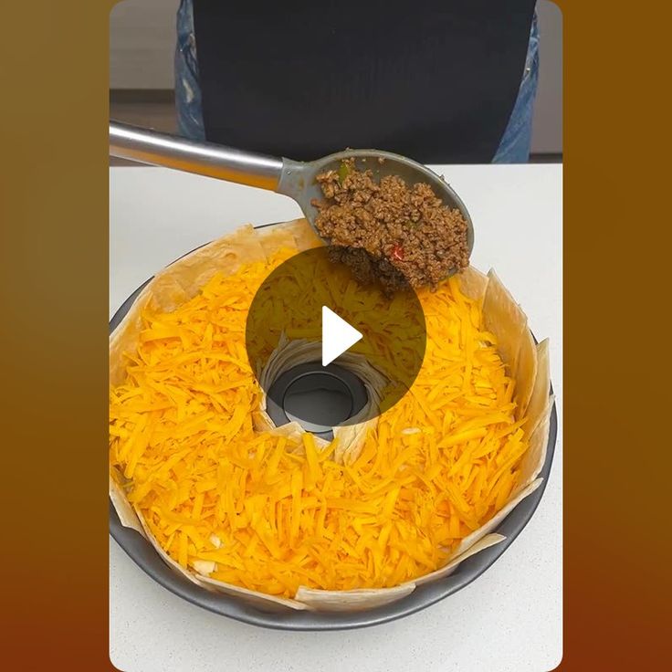 a pan filled with cheese and meat on top of a table