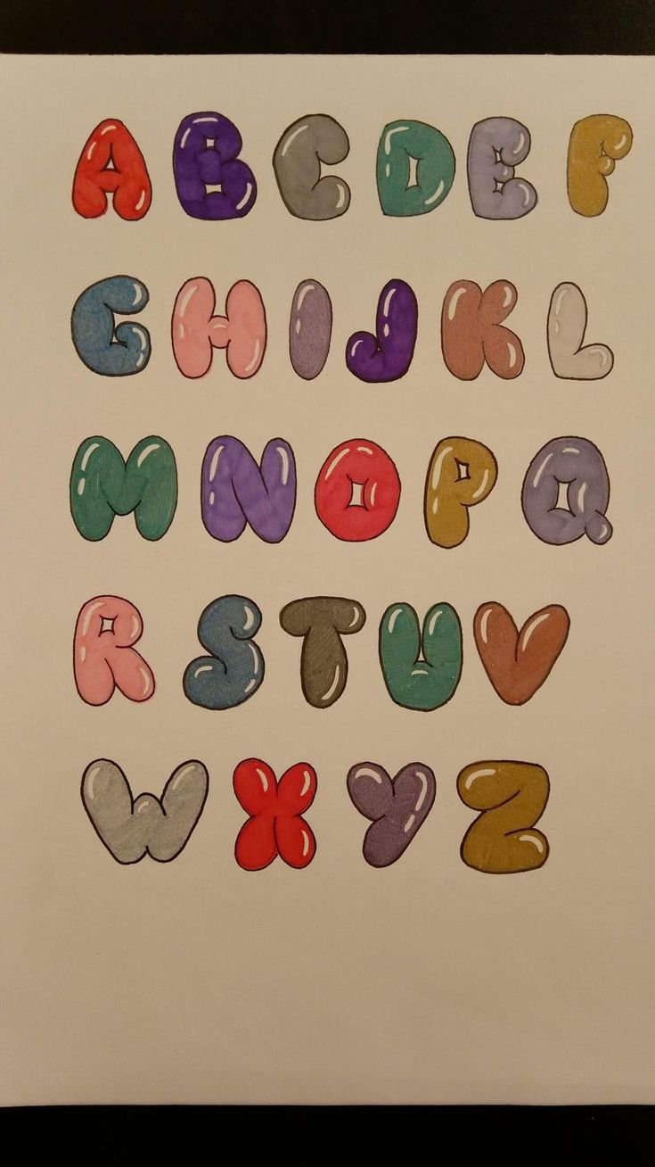 the letters and numbers are drawn with colored crayon pencils on white paper