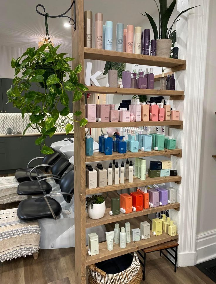 a shelf filled with lots of different types of hair and body care products next to a potted plant