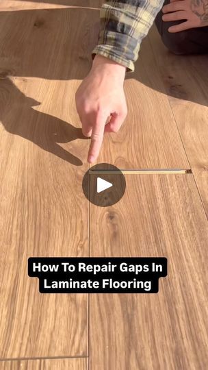 a person pointing to the floor with text overlay that reads how to repair gap in laminate flooring