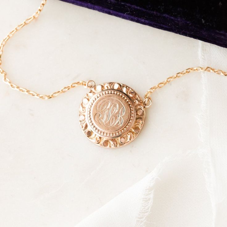 This one-of-a-kind necklace is composed of: Victorian medallion from the late 1800s with the initials "GLB" hand-engraved in the center. This necklace measures a standard 18” on a modern 14k gold filled chain, with the pendant measuring 0.875" in height. Luxury Engraved Medallion Pendant Necklace, Heirloom Coin Pendant Jewelry, Victorian Brass Jewelry With Coin Pendant, Victorian Brass Coin Pendant Jewelry, Heirloom 14k Gold Coin Jewelry, Vintage Gold Medallion Necklace In Sterling Silver, Antique Medallion Jewelry For Commemoration, Classic Gold Engraved Coin Necklace, Luxury Yellow Gold Necklace With Vintage Charm