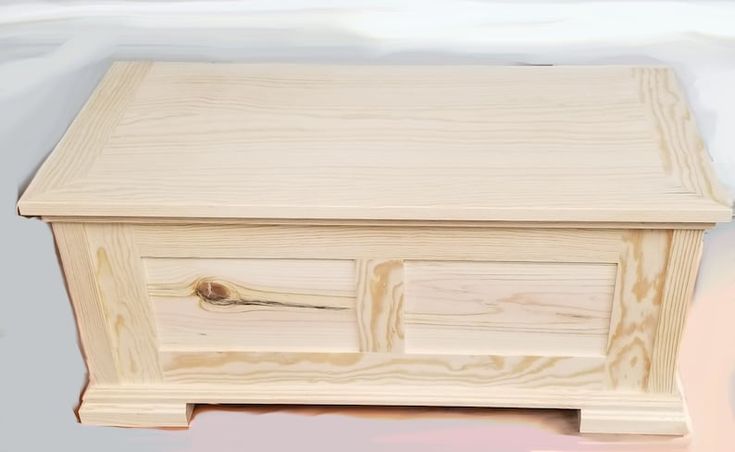 a wooden box sitting on top of a hard wood floor next to a white door