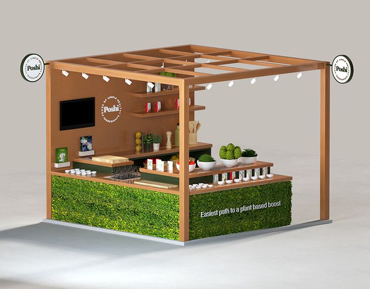 an outdoor food stand with grass growing on the sides and lights hanging from the roof