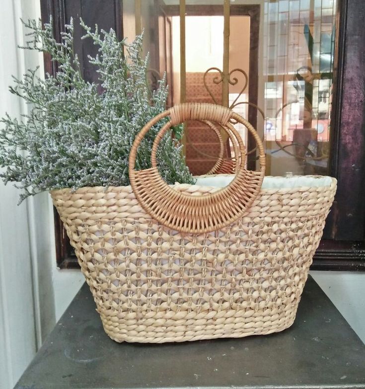 a wicker basket sitting on top of a counter next to a planter and door