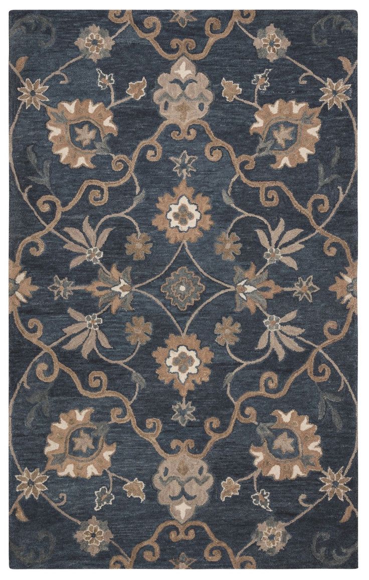 a blue rug with an ornate design on the front and back side, in various colors